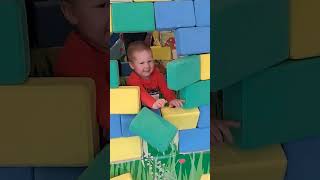 A child rides a carousel on a playground and breaks the wall