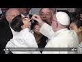 child spontaneously climbs on stage to ask pope francis for his cap