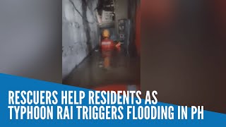 Rescuers help residents as Typhoon Rai triggers flooding in PH