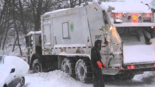 DSNY worker helps guide plow stuck in snow