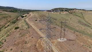 Aerial of Transmissions electricity pylon on the top of Valley in California | Free Stock Video