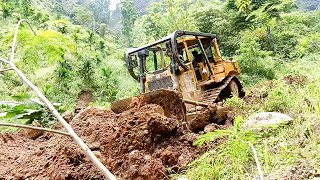 D6R XL Bulldozer Serves to Build Rocky Roads in Mountain Forests