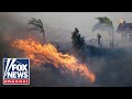 Wind-driven wildfire explodes north of Los Angeles