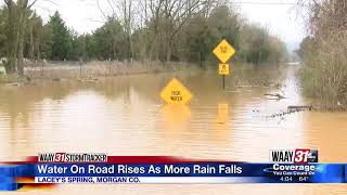 Water on the rise on flooded roads in Lacey's Spring