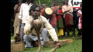 Nearly 1,000 snake charmers held a protest in eastern India Tuesday, playing their flutes as they ma