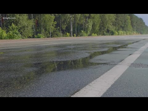 What causes roads to become very slippery after a rain shower in the summer?