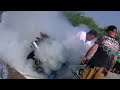 crazy guy eats toxic smoke revving chained down motorcycle as elvis strums guitar