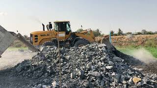 L975F-7T-SDLG Wheel Loader Pushing Rock For Backfill Lake on  Construction Development Area.