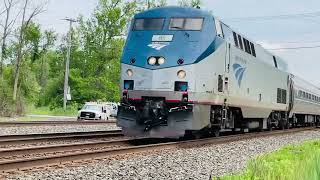 Amtrak 85 races a long westbound stacker  towards  the train with a horn show