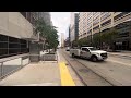 q line streetcar at detroit michigan departs the campus martius stop heading north up woodward ave.