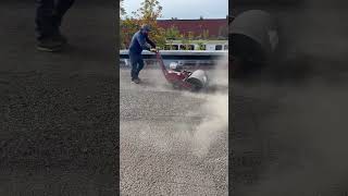 Using our sweeper to remove gravel to begin a rip, 1.5” ISO, smart board and peel and stick cap.