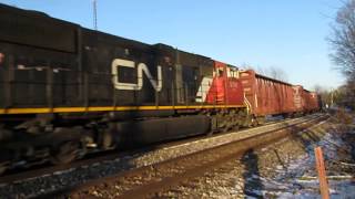 CN 2650, GECX(ex-CSX) 7733, CN 5741 speeding West with a long freight train in Vicksburg, MI