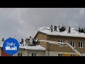 Firefighters and locals battle snow in Rosenau, Austria