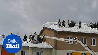 Firefighters and locals battle snow in Rosenau, Austria