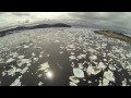 drone video of kayaker paddling through pack ice