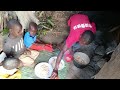 african village lifestyle cooking cassava with groundnuts for lunch.