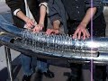 two people playing hydraulophone water pipe organ flute