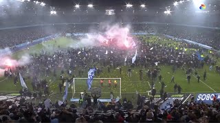Malmo fans storm pitch and mob players with flares and fireworks after winning league.
