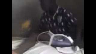 african boy enjoyin his mango fruit ands ends up enjoying the ironing machine...