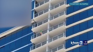 Woman falls, boy seen climbing over high-rise balcony
