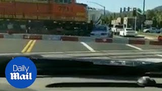 Incredible moment train smashes to pieces car stuck on track