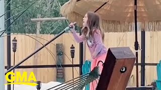 Dad secretly films 8-year-old as she belts ‘Girl on Fire’ while cleaning the pool | GMA