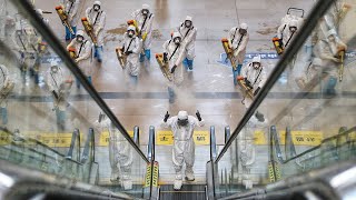 Workers disinfect Hankou railway station in Wuhan