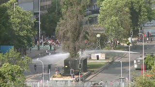 Chilean police fire water cannons at protesters in Santiago | AFP