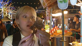 A Japanese woman eats 7 Thai foods at the Thung Sri Muang Festival 2024 in Udon Thani