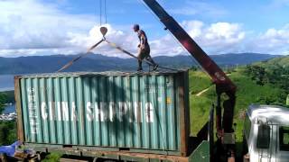 Unloading shipping container - crane on truck