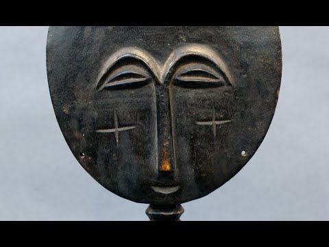 What material is the Akuaba doll carved from?