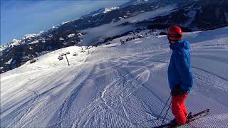 Fast downhill skiing Flachau in the Austrian alps 2018. First morning run on prepped slopes.