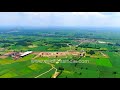 flying low over sardhana in meerut greenery dotted with small structures in bird s eye view