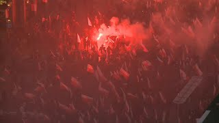 Polish far-right groups march, filling Warsaw streets with red smoke | AFP