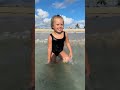 cute toddlers are spending time on the beach