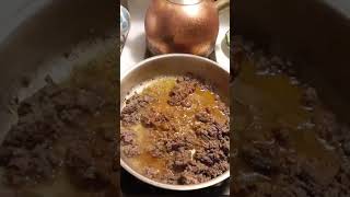 Ground meat cooking with sizzle.