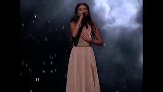 Selena Gomez in a champagne evening dress singing The Heart Wants What It Wants