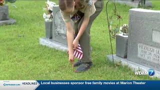 Scouts honor those who serve by placing flags on veteran graves