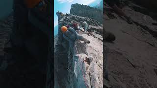 Climbing a mountain with 10,000 foot drops below #shorts