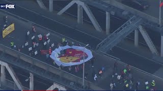 Dozens march across Manhattan Bridge