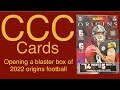 Opening a blaster box of 2022 origins football