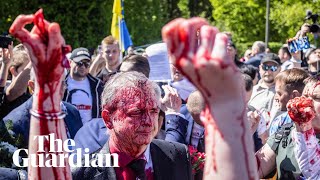 Russian ambassador doused in red by anti-war protesters in Poland