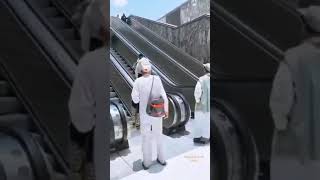 man saving an old women from falling, there is no smartness in getting in an escalator