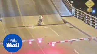 Impatient cyclist gets stuck while trying to cross draw bridge