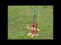 a ukulele doll is swinging ...