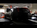 black diamond cts v coupe with borla race mufflers shooting flames.