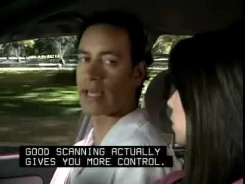 When scanning the road how far down the road should you check?