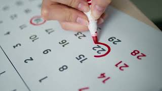 A Person Marking on Calendar (free footage)