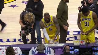 LeBron does his pregame chalk toss and it hilariously falls on AD while he's doing an interview