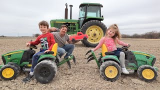Using kids tractors to plow up hidden toys in dirt | Tractors for kids